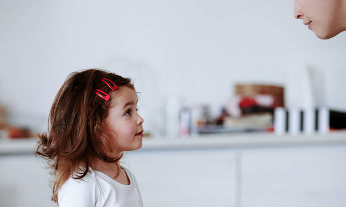 Profile view of girl listening to her mother